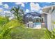 Backyard showcases screened pool with patio area and grill for entertaining at 217 Mariner Ln, Rotonda West, FL 33947