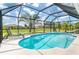 Enclosed pool surrounded by palm trees, featuring lounge chairs for ultimate relaxation and enjoyment at 217 Mariner Ln, Rotonda West, FL 33947