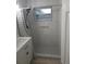 Beautiful bathroom with marble tile walls, a shower with seat, and a window at 2212 Vinson Ave, Sarasota, FL 34232