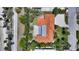 Birds eye view of a single-story home with a terracotta roof, mature landscaping, and an expansive driveway at 223 Seagull Ln, Sarasota, FL 34236