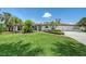 Charming single-story home with a well-manicured lawn, red brick accents, and lush landscaping at 223 Seagull Ln, Sarasota, FL 34236
