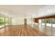 Bright living room features sleek wood flooring, fresh white walls, and sliding glass doors overlooking the outdoor space at 223 Seagull Ln, Sarasota, FL 34236