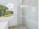 Bathroom featuring a large shower with a glass door and marble tile at 2314 Floyd St, Sarasota, FL 34239