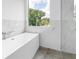 Bright bathroom features a soaking tub and sleek marble tile at 2314 Floyd St, Sarasota, FL 34239