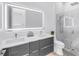 Modern bathroom with double sinks, backlit mirror, and glass shower at 2314 Floyd St, Sarasota, FL 34239