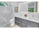 Modern bathroom with dual sinks, a marble-walled shower, and an illuminated mirror at 2314 Floyd St, Sarasota, FL 34239