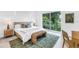 Bedroom with sliding glass doors to balcony, wood accents and modern decor at 2314 Floyd St, Sarasota, FL 34239