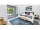 Bedroom with a view to the outdoors, neutral color scheme, and a bench at 2314 Floyd St, Sarasota, FL 34239