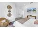 Serene bedroom with modern decor, neutral tones, and a large TV creating a comfortable and stylish retreat at 2314 Floyd St, Sarasota, FL 34239