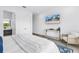 Modern bedroom featuring a large TV, neutral decor, and a comfortable seating area for a relaxing and stylish retreat at 2314 Floyd St, Sarasota, FL 34239