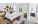 Inviting bedroom with a cozy rug, a comfortable bed, and a large window showcasing lush greenery for a serene retreat at 2314 Floyd St, Sarasota, FL 34239