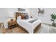 Cozy bedroom with a wooden bed frame and decorative pillows with bedside tables and lamps at 2314 Floyd St, Sarasota, FL 34239