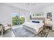 Bright bedroom with a large window, balcony access, and comfortable furnishings offering a relaxing and airy space at 2314 Floyd St, Sarasota, FL 34239