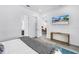 Bedroom view with a television and decorative console table, and ensuite bath at 2314 Floyd St, Sarasota, FL 34239