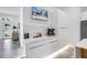 Modern coffee bar area featuring sleek white cabinetry, marble backsplash, and a convenient coffee maker for an elevated beverage experience at 2314 Floyd St, Sarasota, FL 34239