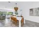 Spacious dining area showcases a modern light fixture, a white table, and seamless access to the living space, promoting connectivity at 2314 Floyd St, Sarasota, FL 34239