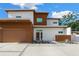 Contemporary home featuring clean lines, a flat roof, wood accents, and manicured landscaping at 2314 Floyd St, Sarasota, FL 34239