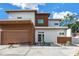 Modern two-story home featuring a sleek design with wood-tone accents and a landscaped front yard with stone walkway at 2314 Floyd St, Sarasota, FL 34239