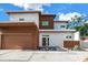 Stunning modern two-story home with a flat roof, brown accents, landscaped front yard, and a two-car garage at 2314 Floyd St, Sarasota, FL 34239