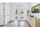 Bright foyer featuring neutral decor, a decorative cabinet, and a view through a glass door to the exterior at 2314 Floyd St, Sarasota, FL 34239