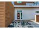 Modern home featuring a contemporary glass front door, low maintenance gravel landscaping with succulent accents, and clean lines at 2314 Floyd St, Sarasota, FL 34239