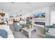 Open-concept living area featuring a modern kitchen, dining space, and comfortable seating around a fireplace at 2314 Floyd St, Sarasota, FL 34239