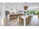 Expansive open-concept living space featuring a modern kitchen, dining area, and a bright living room with sliding glass doors at 2314 Floyd St, Sarasota, FL 34239