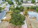 An aerial shot showcases the home's location on a verdant lot with mature trees, as marked by a red boundary at 3205 33Rd Street W Ct, Bradenton, FL 34205