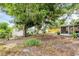Backyard featuring mature trees, a white fence, and a screened porch on the house at 3205 33Rd Street W Ct, Bradenton, FL 34205