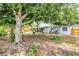 Lush backyard featuring mature trees, a white fence, and a screened-in porch on the house at 3205 33Rd Street W Ct, Bradenton, FL 34205
