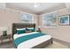Relaxing bedroom with a gray upholstered bed, windows, and side tables with lamps at 3205 33Rd Street W Ct, Bradenton, FL 34205