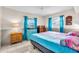 Bright bedroom with two windows, neutral walls, tile floors, and a colorful bedspread at 3205 33Rd Street W Ct, Bradenton, FL 34205