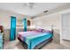 Comfortable bedroom featuring a ceiling fan, neutral walls, and a colorful patterned quilt at 3205 33Rd Street W Ct, Bradenton, FL 34205