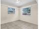 Bedroom featuring neutral walls, tile flooring, and natural light through two windows at 3205 33Rd Street W Ct, Bradenton, FL 34205