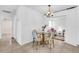 Cozy dining area with tile floors, an elegant chandelier, and an adjoining living space at 3205 33Rd Street W Ct, Bradenton, FL 34205