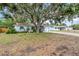 Charming single-story home with a light blue exterior and a well-maintained front yard beneath a mature tree at 3205 33Rd Street W Ct, Bradenton, FL 34205