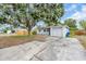 This home features a spacious driveway and garage in front, with a large tree providing ample shade at 3205 33Rd Street W Ct, Bradenton, FL 34205