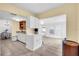 Open concept kitchen with white cabinetry and island that flows to the dining room and bright living area at 3205 33Rd Street W Ct, Bradenton, FL 34205