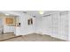 Open-concept living room featuring easy access to the laundry room and kitchen with built in bookcase at 3205 33Rd Street W Ct, Bradenton, FL 34205