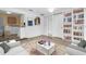 Open-concept living room featuring built in bookcase and easy access to the laundry room and kitchen at 3205 33Rd Street W Ct, Bradenton, FL 34205