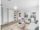 Bright living room featuring large windows, modern furnishings, neutral walls, and built in bookcase at 3205 33Rd Street W Ct, Bradenton, FL 34205