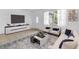 Modern living room with neutral furniture, tile flooring, and ample natural light creating a comfortable atmosphere at 3205 33Rd Street W Ct, Bradenton, FL 34205
