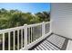 A balcony with view of tropical trees and greenery, with a white railing at 3409 10Th W Ln, Palmetto, FL 34221