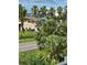 A partial view from a balcony, featuring palm trees and other lush vegetation at 3409 10Th W Ln, Palmetto, FL 34221