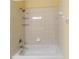 Clean white bathtub with tiled walls and shower head at 3409 10Th W Ln, Palmetto, FL 34221