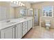 Bathroom with double vanity, shower and toilet with window providing ample natural light at 3409 10Th W Ln, Palmetto, FL 34221