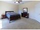 Spacious carpeted bedroom featuring a queen bed, matching nightstands, and a dresser at 3409 10Th W Ln, Palmetto, FL 34221