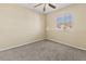 A sunny carpeted bedroom with ceiling fan and a large window at 3409 10Th W Ln, Palmetto, FL 34221