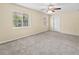 Spacious bedroom with carpet flooring, neutral walls, a ceiling fan, and two windows with plenty of natural light at 3409 10Th W Ln, Palmetto, FL 34221