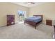 Cozy bedroom with carpet, ceiling fan, a dresser and sliding doors to a balcony with water view at 3409 10Th W Ln, Palmetto, FL 34221
